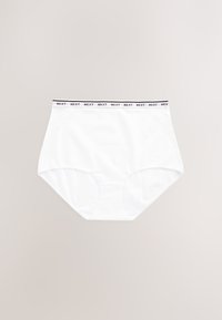 Culotte blanche taille haute avec ceinture élastique affichant le logo "NEXT" répété sur un fond beige uni.
