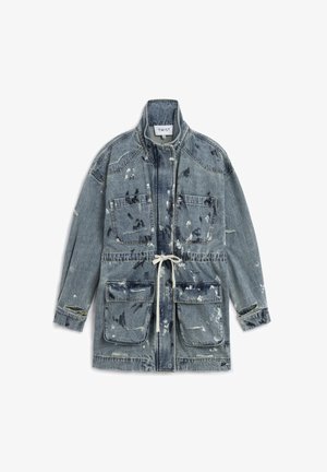 Denim jacket with high collar, four large front pockets, drawstring waist, and distressed paint splatters and rips throughout.