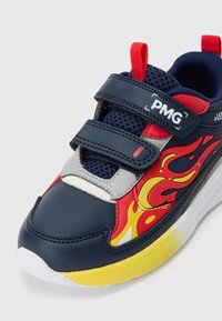 Laste tumesinine sneaker punase ja kollase leegikujundusega, kahe Velcro rihmaga, võrgust keel ja valge tald kollase aktsendiga.