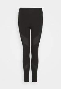 Svarta leggings med hög midja och en figursydd design. Har genomskinliga nätpaneler i ett V-mönster längs sidorna för ventilation.