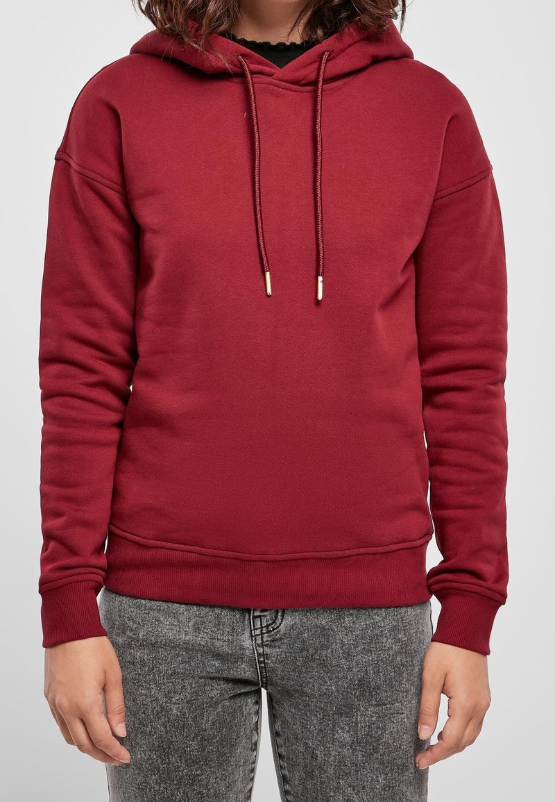 Sudadera con capucha en color granate con bolsillo frontal tipo canguro, capucha con cordón, puños y dobladillo acanalados, confeccionada en un tejido suave y texturizado.