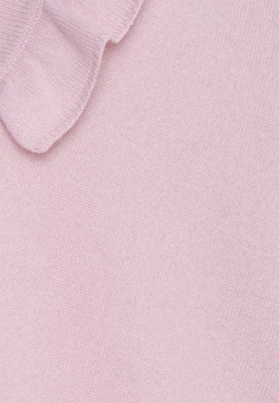 Tecido de malha em rosa claro com um acabamento flutuante ao longo da borda, proporcionando uma textura suave e um detalhe de design subtil.