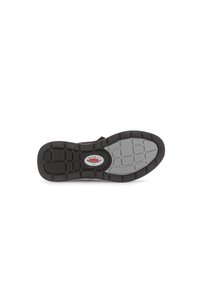 Black rubber shoe sole featuring a textured pattern with gray accents and a circular logo, designed for grip and durability.