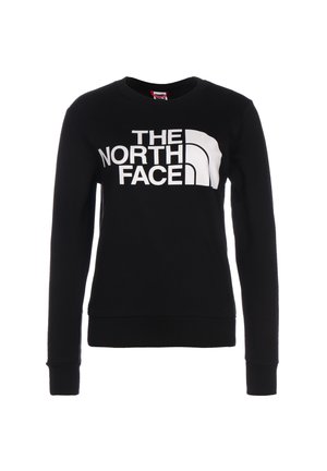 Musta, pitkähihainen, pyöreäkauluksinen collegepaita, jossa suuri valkoinen "THE NORTH FACE" -logo ja tunnus edessä keskellä.
