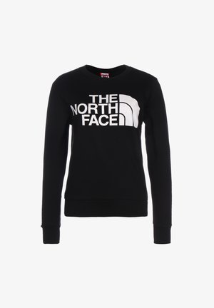 Czarna bluza z długim rękawem i okrągłym dekoltem z dużym białym logo i emblematem "THE NORTH FACE" umieszczonym na środku z przodu.