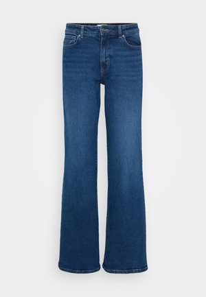 Tumedad sinised flare-denim püksid klassikalise viie tasku disainiga, nööbikinnitus ja vöökohad. Sile tekstuur minimaalse kulumisega.