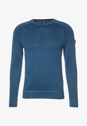 Pull en maille bleu avec des manches longues, col rond, tissu texturé et détails de couture contrastés. Écusson logo sur la manche gauche.