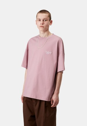 Camiseta oversized de color rosa claro, hecha de algodón y con hombros caídos. Presenta un logo bordado en blanco en el lado izquierdo del pecho.