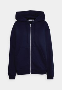 Marineblå hættetrøje med lynlås, lavet af blød bomuld, med en stor hætte, to frontlommer og ribkant ved ærmegabene. Ren design uden mønstre.