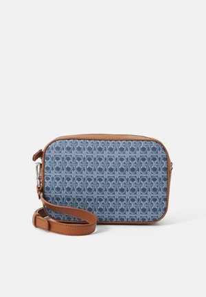 Blue patterned fabric crossbody bag with brown leather accents and a detachable strap. Rectangular shape with zip closure and textured design.