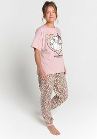 Cotton pink t-shirt with a cartoon print features and short sleeves, paired with beige joggers in a pink and brown leopard print pattern.