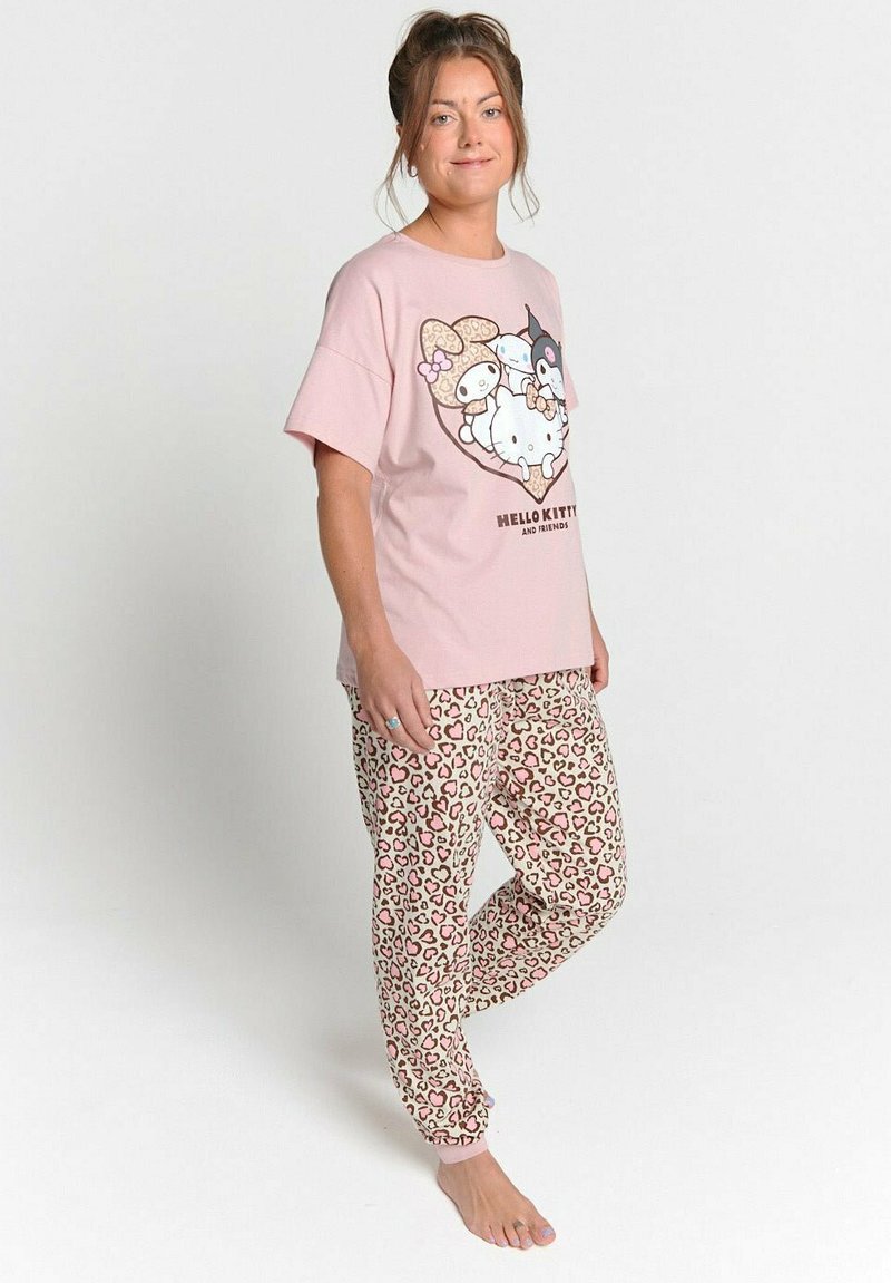 Cotton pink t-shirt with a cartoon print features and short sleeves, paired with beige joggers in a pink and brown leopard print pattern.