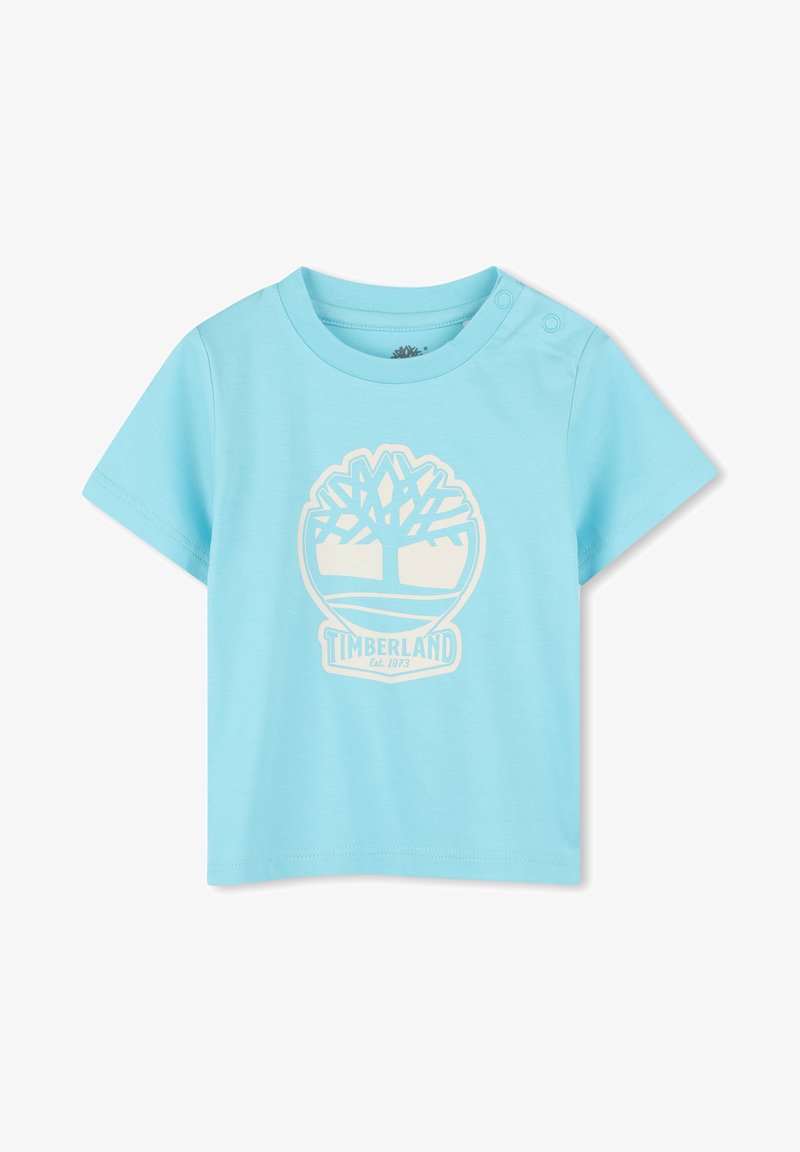 Lichtblauw kortarm t-shirt van katoen. Heeft een witte Timberland logo graphic in het midden, met drukknoopjes op de schouders.