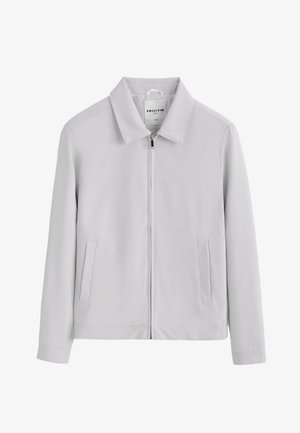 Veste gris clair à manches longues avec col, fermeture éclair à l'avant et deux poches latérales verticales, taille M indiquée par la marque Frilivin.