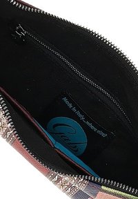 Interno di portafoglio colorato e decorato con una fodera in tessuto nero, dotato di una tasca con zip e un'etichetta blu che riporta la scritta "Gabs".