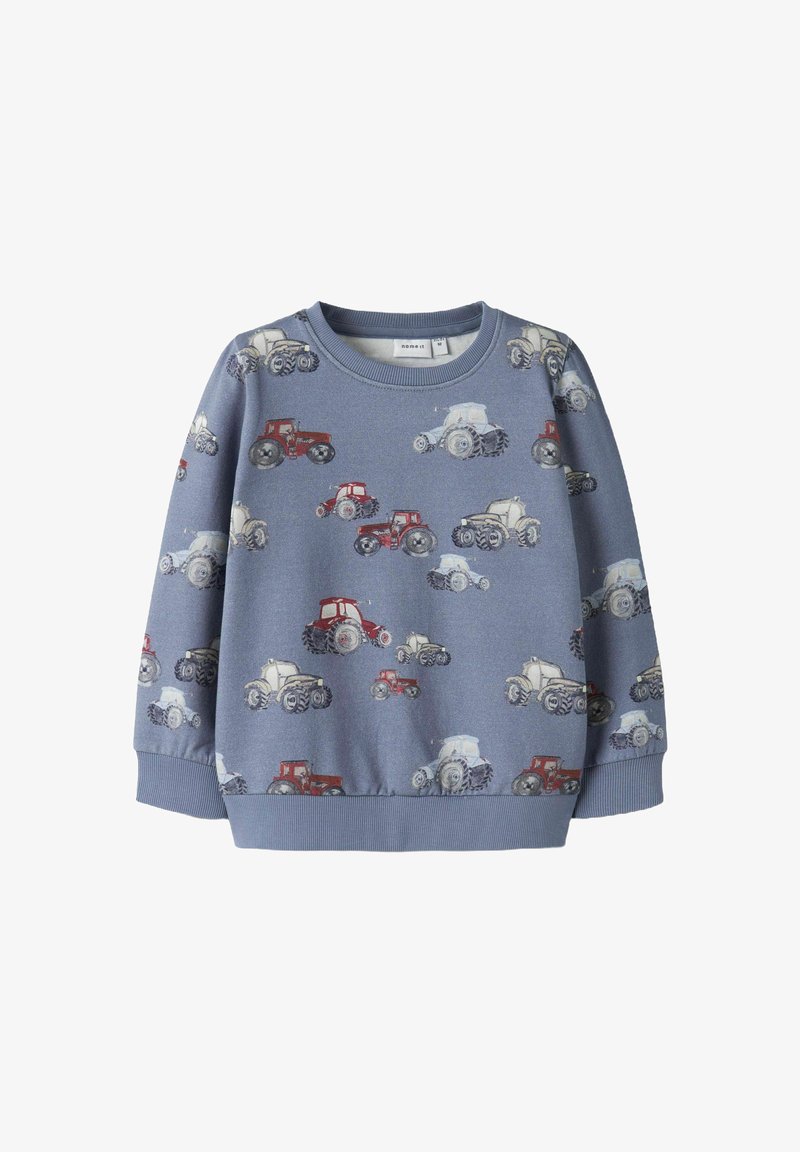 Zils džemperis ar atkārtotu tēmu – traktori sarkanā, baltā un pelēkā krāsā. Izgatavots no mīkstas auduma ar ribotiem aprocēm un apakšmalu.