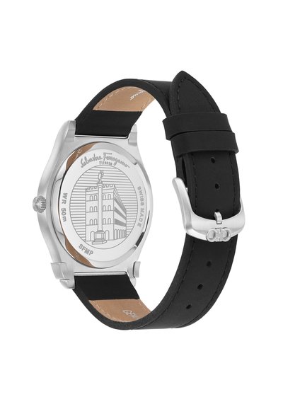 Silver stainless steel watch with a black rubber strap. The back features engraved column design and "Swiss Made" text.