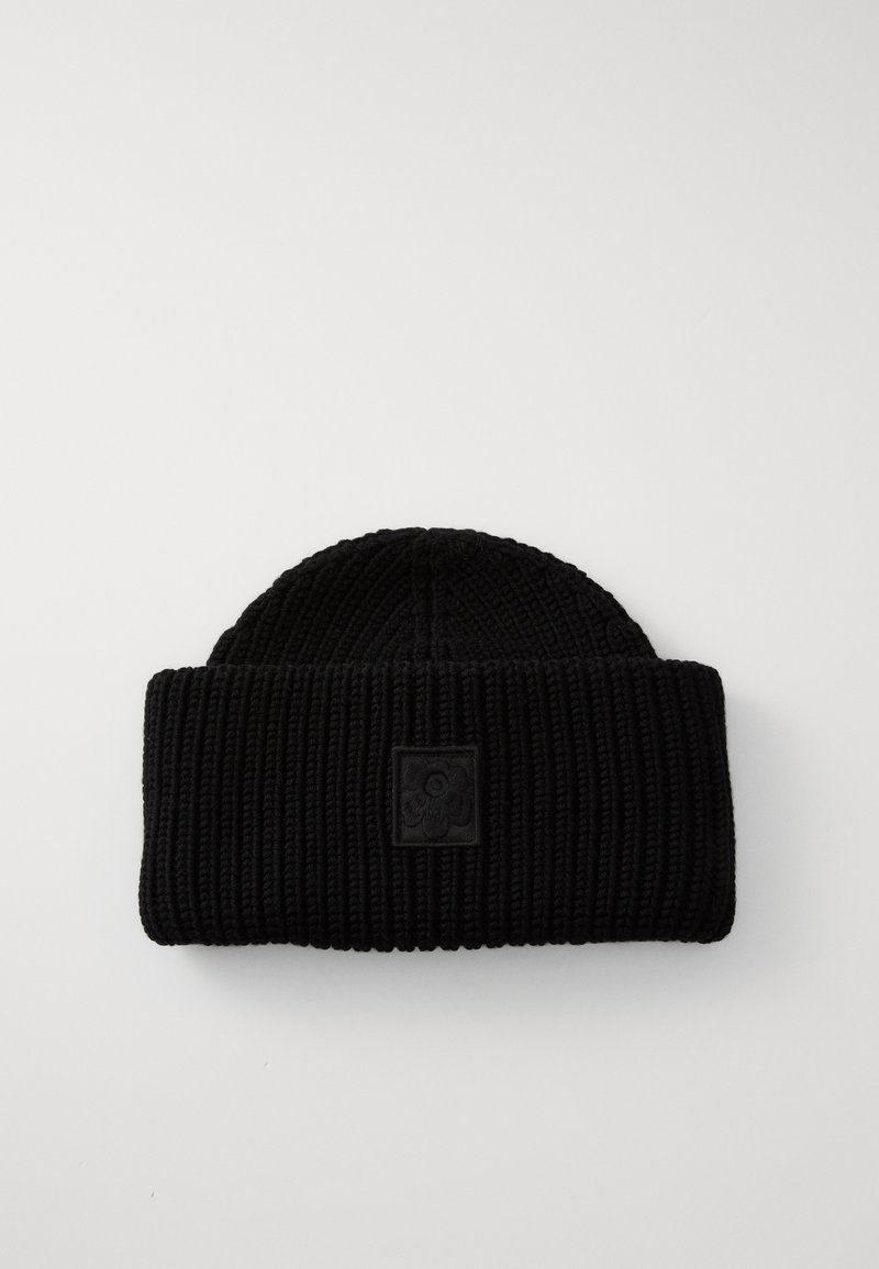 Black knit beanie with ribbed texture, featuring a folded cuff and a square black patch with a floral design on the front.