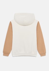 Φούτερ με κουκούλα με κρέμ σώμα και μπεζ μανίκια. Διαθέτει απαλό υλικό και ριμπ μανσέτες. Σχεδιασμένο με κουκούλα που ρυθμίζεται με κορδόνι.