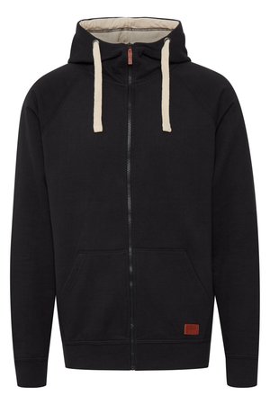 Mustahiili zip-up huppari, jossa on kerma värinen nyöri, etutaskut, raglan-hihat, ribbireunat ja teksturoitu ruskea merkki alhaalla oikealla.