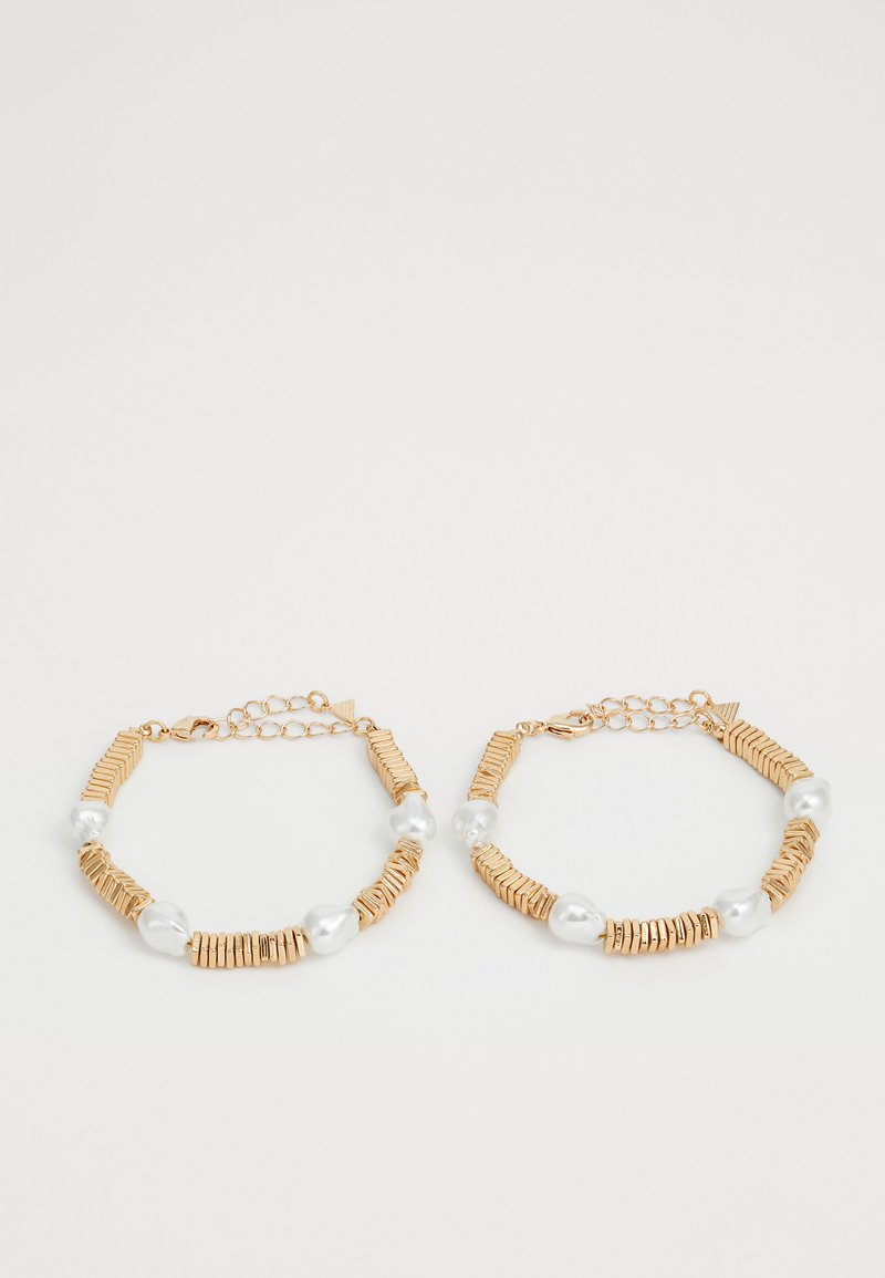 Gold-tone bracelets featuring alternating flat metal and natural pearl beads. Includes adjustable chains for size customization.