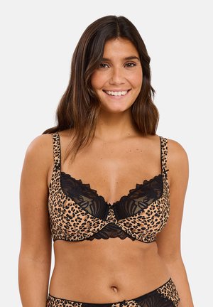 Soutien-gorge en imprimé léopard avec des accents en dentelle noire, doté de bretelles réglables et d'une texture de tissu lisse. Les bonnets doux offrent confort et style.
