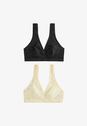 Divi mežģīņu bralete ar dziļu V veida izgriezumu, viena melna un viena bēša, izvietotas plakanā uz balta fona.