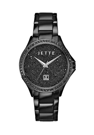 Montre-bracelet noire avec un cadran texturé, des accents en cristal et un bracelet en métal noir lisse. Présente des aiguilles argentées et le nom de la marque "JETTE."