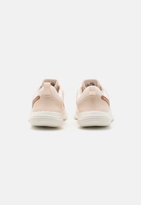 Light pink athletic shoes with mesh fabric, padded collar, and white rubber soles. Features a small brown accent on the heel.