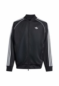 Μαύρο αθλητικό μπουφάν με λευκό σχέδιο τριών ρίγων στα μανίκια, ριμπ ύφανση στις μανσέτες και το γιακά, και φερμουάρ στο μπροστινό μέρος. Διαθέτει μικρό λογότυπο στο στήθος.