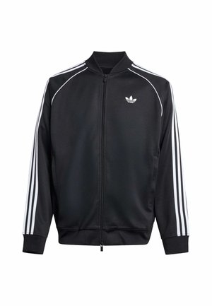 Juoda sportinė striukė su balta trimis dryželiais ant rankovių, ribiniu apvadu rankogaliuose ir apykaklėje bei užtrauktuku. Krūtinėje yra mažas logotipas.