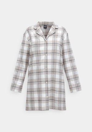 Geruite shirt in wit, beige en marineblauw. Gemaakt van een lichte stof, met een knoopsluiting aan de voorkant en lange mouwen. Opvallend kraagontwerp.