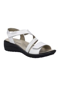 Białe sandały z krzyżującymi się paskami, górna część z gładkiego materiału przypominającego skórę, regulowane zapięcie na rzep, wyściółka z miękkiej podeszwy i czarna gumowa podeszwa.