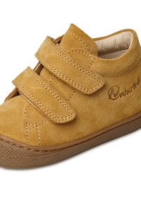 Scarpe in suede di colore giallo senape con due cinturini in velcro. Presentano una suola in gomma con una superficie texturizzata e dettagli cuciti.