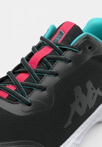 Black athletic shoe with textured mesh upper, pink and turquoise laces, and a white sole. Features a Kappa logo in black on the side.