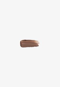 Smooth, horizontal light brown makeup foundation swatch with visible brush strokes on a plain white background.