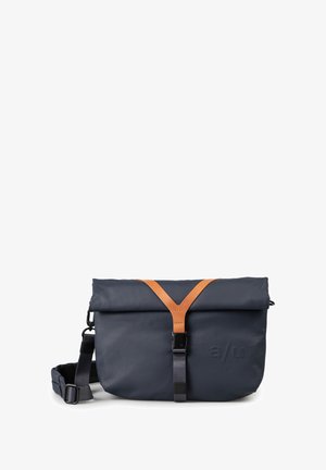 Navy roll-top bag crafted from durable material, featuring a brown leather strap, adjustable shoulder strap, and embossed logo detail.