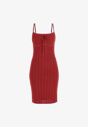 Red knitted dress with thin straps, featuring a fitted silhouette, ribbed texture, and a tie detail at the front.