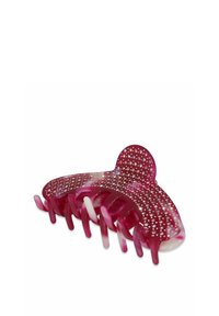 Pinza de pelo de plástico rosa con forma redondeada, que presenta una superficie texturizada y adornada con piedras de rhinestones claras en la parte superior.