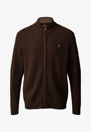 Man wearing dark brown zip-up sweater, dark blue jeans with cuffs, and brown leather lace-up boots standing on white background.