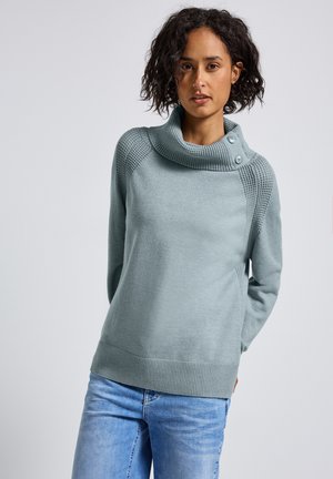 Pull bleu clair avec un col en cowl et deux boutons décoratifs. Présente des accents texturés aux épaules et des poignets et un ourlet côtelés.