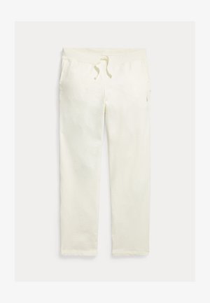 Krémové voľnočasové tepláky so sťahovacou šnúrkou v páse a bočnými vreckami, zobrazené na svetlom pozadí.