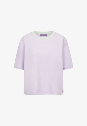 Jasnofioletowa koszulka z krótkim rękawem i okrągłym dekoltem, z białą lamówką przy kołnierzu oraz małym okrągłym logo w pobliżu dolnego brzegu.