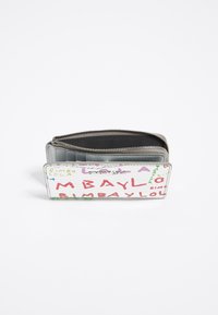Zippered wallet in white leather featuring multicolored text patterns. Interior has a gray fabric lining with card slots and compartments.