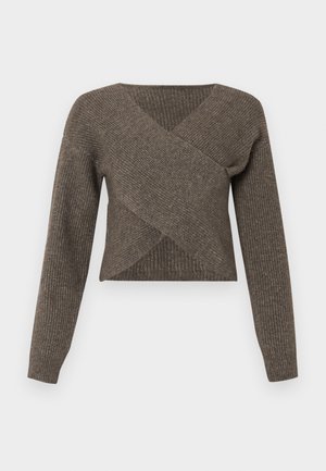 Brown cross-over sweater with long sleeves, ribbed texture, and a deep v-neckline, made from soft knit material. Cropped design.
