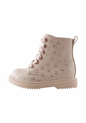 Light beige ankle boot with satin ribbon laces and a subtle cherry pattern on smooth leather and a thick rubber sole.
