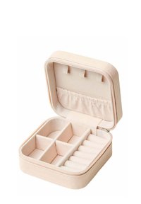 Boîte à bijoux en tissu rose tendre, de forme rectangulaire avec fermeture éclair. Comprend des compartiments pour les bagues et les petits objets, intérieur douillet.