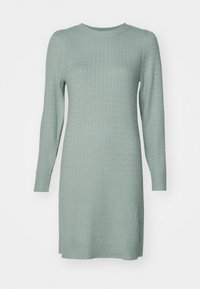 Robe en maille à manches longues de couleur vert menthe clair, présentant un motif texturé avec un col et un ourlet côtelés. Coupe régulière et longueur genou.