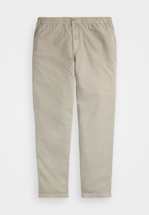 Calças caqui com cintura elástica, fecho de botão e bolsos laterais. Feitas de um suave e leve tecido de algodão, corte de perna reta.