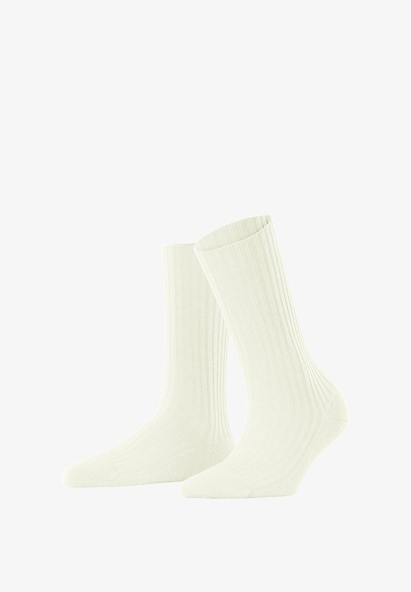 Calzini a coste color crema con un design di lunghezza media, caratterizzati da una texture morbida e una punta arrotondata, adatti per l'abbigliamento casual.